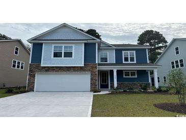 Charming two-story home with blue siding, stone accents, and a well-maintained front yard at 1228 Barrington Way, Conway, SC 29526