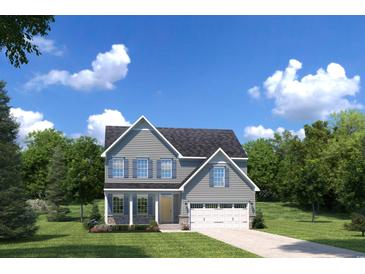 Charming two-story home features a two-car garage, light gray siding, and a well-manicured lawn at 1517 Hope Pointe Dr, North Myrtle Beach, SC 29582