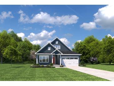 Charming two-story home featuring a red door, white garage, and well-manicured lawn at 1605 Hope Pointe Dr, North Myrtle Beach, SC 29582