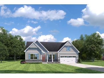 Charming single-Gathering home featuring stone accents, blue shutters, a two-car garage and manicured lawn at 1625 Hope Pointe Dr, North Myrtle Beach, SC 29582