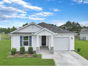 Charming single-story home with white siding, manicured lawn, and inviting front entrance at 182 Foxford Dr., Conway, SC 29526