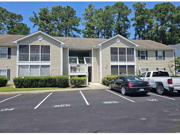 Inviting condo with a tan exterior, screened porch, and well-maintained landscaping in a desirable neighborhood at 197 Charter Dr. # D1, Longs, SC 29568