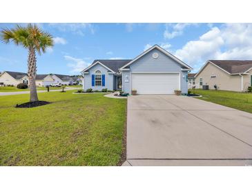 Charming single-story home with a two-car garage and a well-maintained lawn with mature palm tree at 252 Heath Dr., Longs, SC 29568