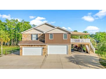 Spacious home featuring a multi-car garage, stone accents, and covered boat parking at 3721 Ed Smith Ave., Myrtle Beach, SC 29588