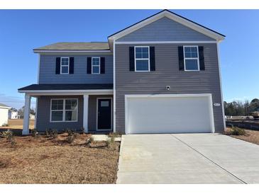 Two story home with a two car garage, black shutters and light gray siding on a sunny day at 374 Acosta Circle, Conway, SC 29527