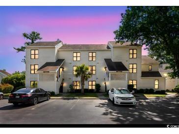 Charming condo with well-lit exterior, lush landscaping, and ample parking at 4510 Little River Inn Dr. # 2708, Little River, SC 29566