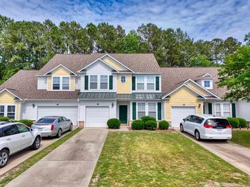 Inviting townhome with manicured lawn, attached garages, and charming curb appeal at 6203 Catalina Dr. # 212, North Myrtle Beach, SC 29582