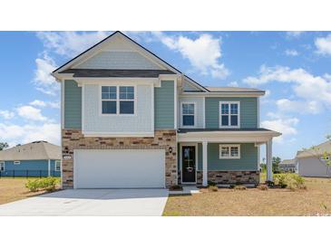 Charming two-story home featuring a stone-accented facade, attached garage, and a welcoming front porch at 744 Choctaw Dr., Conway, SC 29526