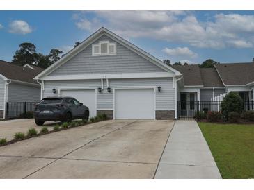 Charming home featuring a two-car garage, gray siding, and well-maintained landscaping at 797 Salerno Circle # C, Myrtle Beach, SC 29579