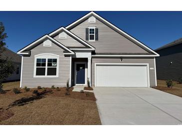 Charming single-Gathering home featuring a 1-car garage, landscaped yard, and classic architectural details at 869 Farmers Passage Loop, Loris, SC 29569