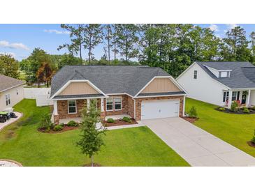 Beautiful single-story home with a well-manicured lawn and attached two-car garage at 131 Crabapple Dr., Longs, SC 29568