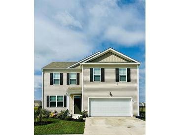 Two-story home featuring neutral siding, black shutters, a two-car garage, and a well-manicured lawn at 1709 Perthshire Loop, Myrtle Beach, SC 29579