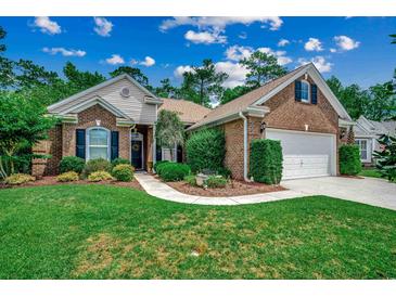 Charming brick home with a well-manicured lawn and inviting landscaping, offering great curb appeal at 24 Willowbend Dr., Murrells Inlet, SC 29576