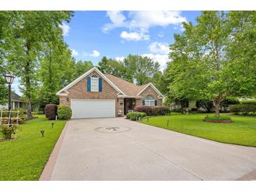 Charming brick home with manicured lawn, two-car garage, and inviting curb appeal at 2636 Brick Dr., Longs, SC 29568