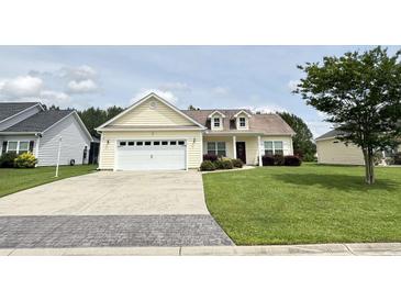 Charming single-story home with a well-manicured lawn, a two-car garage, and attractive landscaping at 348 Basswood Ct., Conway, SC 29526