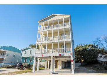 Inviting three-story beach house featuring private balconies and ground-level parking at 400 Hillside Dr. S, North Myrtle Beach, SC 29582