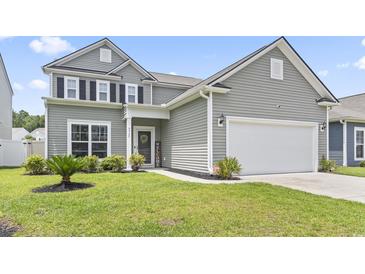 Charming two-story home with gray siding, manicured lawn, and attached two-car garage at 4927 Sandlewood Dr., Myrtle Beach, SC 29579