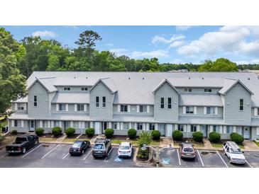 Exterior view of a two-story condo building featuring light blue siding, a gray roof, and well-maintained landscaping at 510 Fairwood Lakes Dr. # 923G, Myrtle Beach, SC 29588