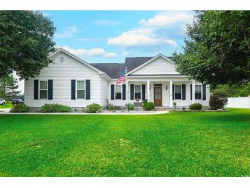Charming one-story home features a green lawn, American flag, and classic curb appeal at 548 Fox Chase Dr., Conway, SC 29527