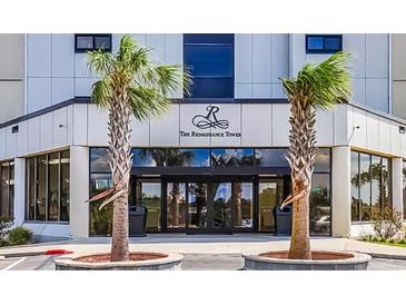 Renaissance Tower building entrance featuring palm trees and glass doors reflecting the beautiful surroundings at 5905 S Kings Hwy. # 1816 Rt, Myrtle Beach, SC 29575