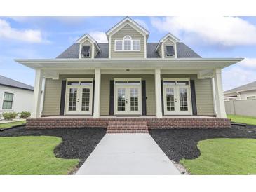 Charming one-story home featuring a brick foundation, gabled windows, and a welcoming front porch at 853 Bluffview Dr., Myrtle Beach, SC 29579