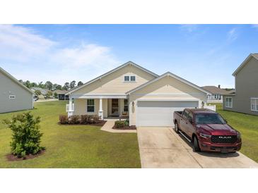 Charming single-story home with a well-manicured lawn and attached two-car garage at 905 Sewing Bee Pl., Little River, SC 29566