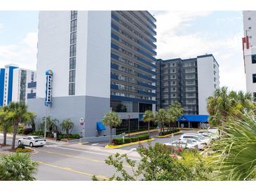 Coastal condominium building with blue accents, palm trees, and well-maintained landscaping at 2001 S Ocean Blvd. # 303, Myrtle Beach, SC 29577