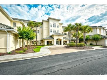 Beautiful building exterior features manicured landscaping, sidewalks, and palm trees against a cloudy sky at 2180 Waterview Dr. # 635, North Myrtle Beach, SC 29582