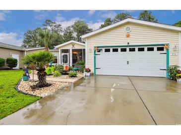 Charming home featuring a one-car garage, vibrant landscaping and an inviting screened-in porch at 356 Lakeside Crossing Dr., Conway, SC 29526