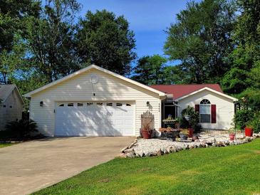 Charming single-story home boasts a two-car garage and beautifully landscaped front yard with decorative rock and shrubbery at 3904 Williamson Circle, Myrtle Beach, SC 29579
