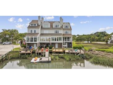 Beautiful waterfront home featuring multiple decks, an outdoor seating area and a private dock at 465 Vereen Rd. # 10, Murrells Inlet, SC 29576