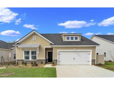 Charming home with a large garage, beautiful landscaping, and neutral colored siding at 5039 Selene Ct., Myrtle Beach, SC 29588