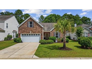 Charming brick home with a well-manicured lawn, mature trees, and an attached two-car garage at 5149 Morning Frost Pl., Myrtle Beach, SC 29579