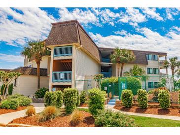 Beautiful exterior of a condo building with palm trees and manicured landscaping on a sunny day at 5601 N Ocean Blvd. # C-314, Myrtle Beach, SC 29577