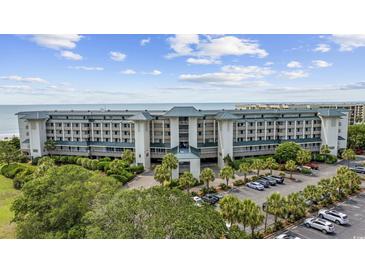 Beautiful multi-story condo building offers stunning ocean views with lush landscaping and ample parking at 601 Retreat Beach Circle # 213, Pawleys Island, SC 29585