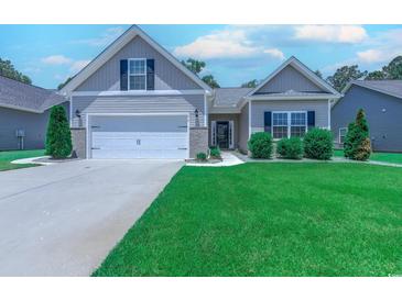 Charming home featuring a two-car garage, manicured lawn, and inviting curb appeal at 617 Chiswick Dr., Conway, SC 29526