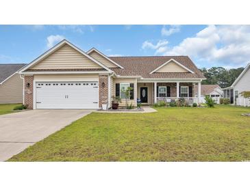 Charming single-story home with a well-maintained lawn, attached garage, and inviting front porch at 716 Weston Dr., Conway, SC 29526
