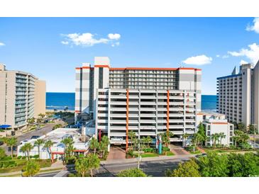 Bright condo building with multiple levels of covered parking near the ocean and local establishments at 7200 N Ocean Blvd. # 553, Myrtle Beach, SC 29572