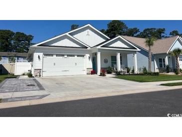 Charming single-story home boasts a manicured lawn and a two-car garage at 1039 Graybill Lane, North Myrtle Beach, SC 29582