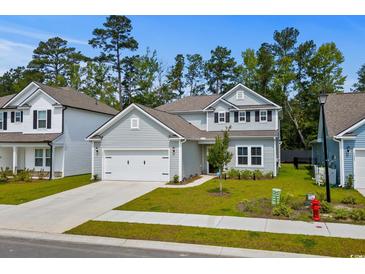 Charming two-story home with grey siding, attached garage and well-manicured lawn at 1331 Winding Creek Way, Myrtle Beach, SC 29588