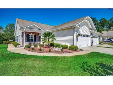 Charming single-story home with a well-manicured lawn, mature landscaping, and a two-car garage at 204 Rose Water Loop # 204, Myrtle Beach, SC 29588