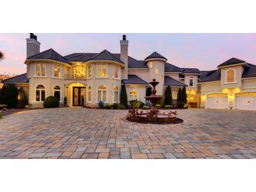 Stunning, multi-story home featuring a circular driveway with fountain and meticulous landscaping at 2715 Ships Wheel Dr., North Myrtle Beach, SC 29582
