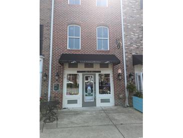 Charming boutique with brick exterior and classic storefront design, inviting customers inside at 2834 Howard Ave. # D, Myrtle Beach, SC 29577