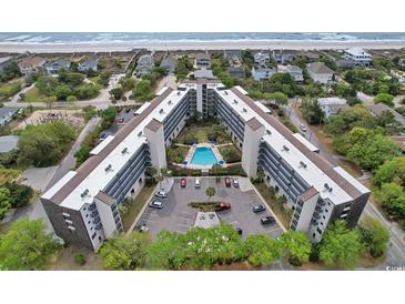 Enjoy the beautiful aerial view of this oceanfront condo with a swimming pool and on-site parking at 423 Parker Dr. # 334, Pawleys Island, SC 29585