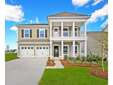 Charming two-story home with a welcoming porch, well-manicured lawn, and three-car garage at 5034 Selene Ct., Myrtle Beach, SC 29588