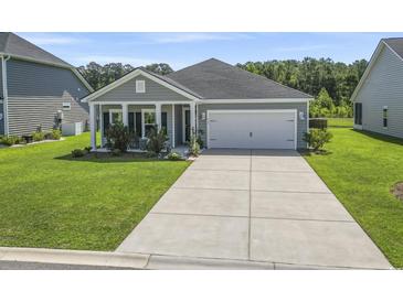 Charming single-story home featuring a well-manicured lawn and a two-car garage at 519 Royal Jay Ln., Longs, SC 29568