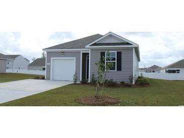 Charming one-story home with attached garage, well-manicured lawn, and a welcoming entrance at 575 Strawberry Field Way, Galivants Ferry, SC 29544