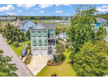 Charming two-story home with a two-car garage, screened porch and views of a tranquil pond at 601 46Th Ave. S, North Myrtle Beach, SC 29582