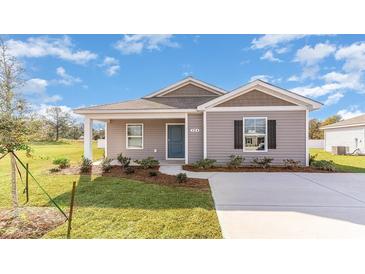 Charming single-story home with gray siding, complemented by a well-manicured lawn and lush landscaping at 659 Culmen Ct., Myrtle Beach, SC 29588