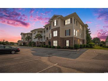 Inviting condo complex showcases brick and siding details, manicured landscaping and convenient parking at 730 Pickering Dr. # 303, Murrells Inlet, SC 29576